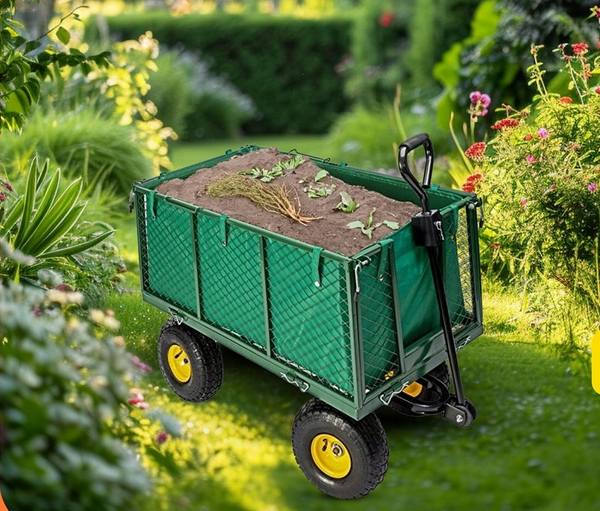 Sklep - strefamarki - Dom i ogród w jednym miejscu - 07 - strefamarki Green garden cart filled with soil and small plants in a sunlit backyard. An outdoor scene with lush plants and flowers around it.- 07