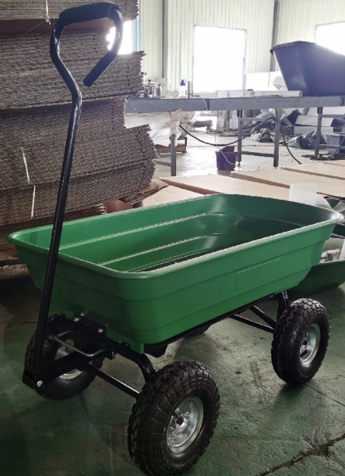 Sklep - strefamarki - Dom i ogród w jednym miejscu - Wózek ogrodowy nr1 c - strefamarki Green plastic utility wagon with a black metal frame and large off-road tires in a workshop setting.- Wózek ogrodowy nr1 c