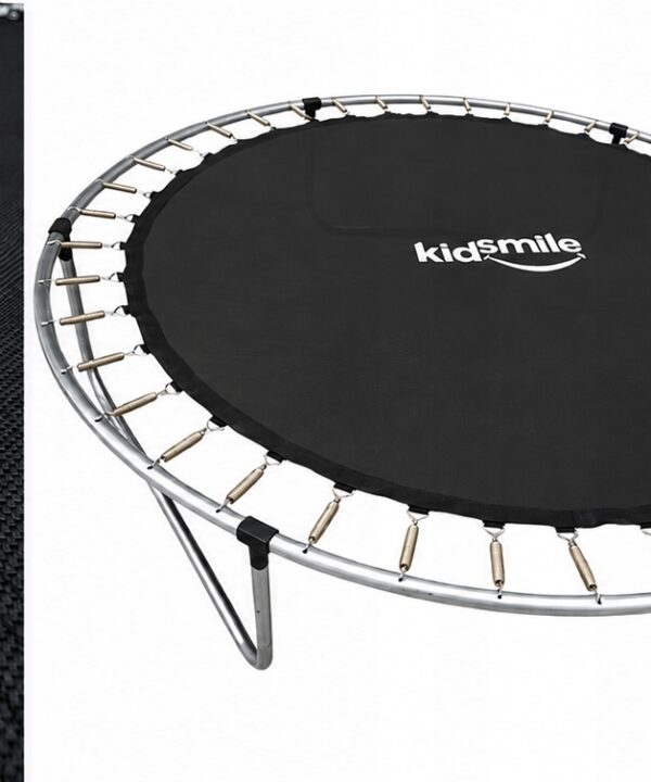 Round mini trampoline with a black jumping mat labeled 'kidSmile' and exposed metal springs on a white background, with a pink playground seat visible on the right