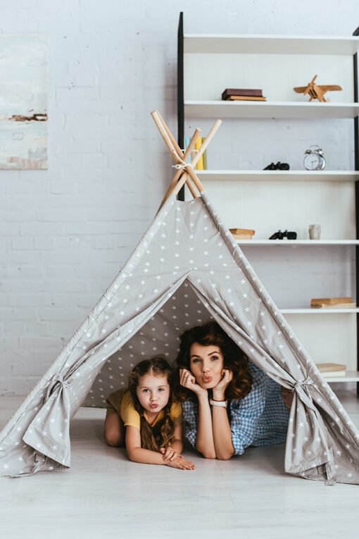 - cute child and young nanny making duck faces and looking at came 